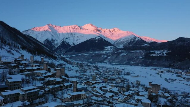 Small town in winter in a stunning mountain valley aerial view, done video. Mestia Svaneti Georgia