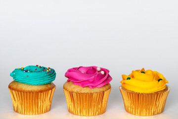 Cupcakes with cream icing on white background with copy space for text