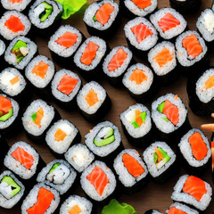 japanese sushi food. Maki and rolls with tuna, salmon, shrimp, crab and avocado. Sushi assortment top view. Rainbow sushi roll, uramaki, hosomaki and nigiri.
