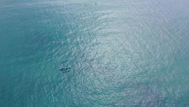 Aerial view of a fishing boat with fish and a net. Calm beautiful video on the background for tourism, design and advertising.