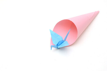 A blue paper origami bird and cone