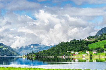 Fototapeta na wymiar The village in the lake next to a fiord in Norway