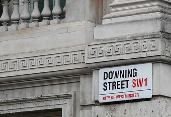 Downing Street sign on the wall of a building in Westminster, London, England, UK. 