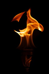 Flames dancing on top of a martini glass, inspirational that one should control what one has control over. nature and natural beauty isolated against a black backdrop.