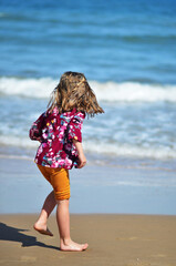 Happy barefoot child have fun on beach