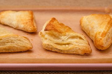 Apple turnover close-up on a baking pan