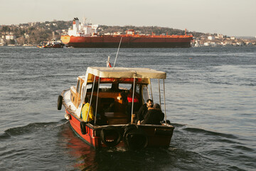 The boat at sea and the cargo ship behind it in kanlica Istanbul, turkey