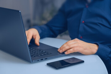 Manager using laptop at home office for financial management and research. Laptop and hands of business man typing project ideas and planning at desk.