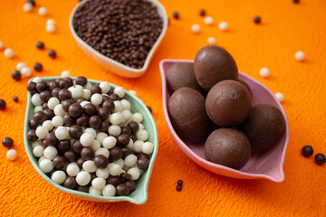 baskets of chocolate balls on an orange background