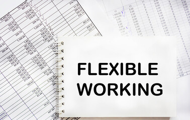 FLEXIBLE WORKING text in office notepad with documents, business