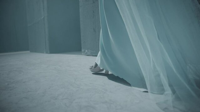 Rear back view of blonde woman walking inside dark maze with bridal crown . Footage of mystic video of bride in labyrinth . Vision of mystical dream . Shot on ARRI ALEXA Cinema Camera in slow motion .