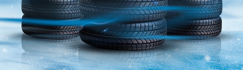 Stack of wheel new black tyres for winter car driving isolated on colored background