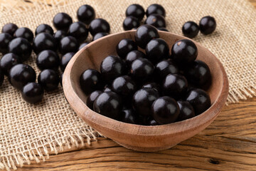 Jabuticabas on a bowl over wooden table