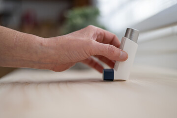 Front View Of A Hand Holding An Asthma Or Allergy Inhaler. Medicines And Health Care