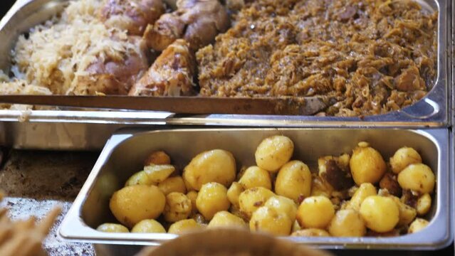 Big Pan Of Polish Bigos And Fried Potatoes In A Street Restaurant On Saint