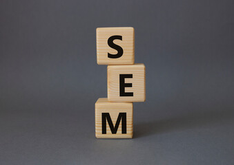 SEM - Search Engine Marketing symbol. Wooden cubes with words SEM. Beautiful grey background. Business and SEM concept. Copy space.