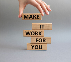 Make it work for you symbol. Business Concept words Make it work for you on wooden blocks. Beautiful grey background. Businessman hand. Business concept. Businessman hand. Copy space