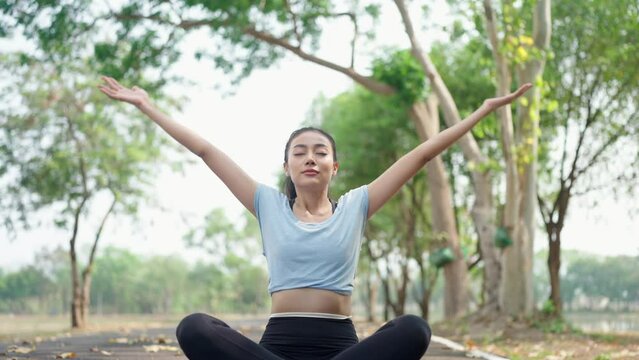 Fitness woman stretching before or after workout, Asian fit girl workout exercise in the morning at nature park outdoor, sport fitness lifestyle for athlete body to wellness healthy