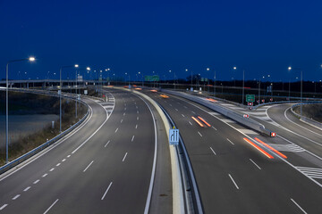 Fototapeta na wymiar highway crossroad at night with modern street lights