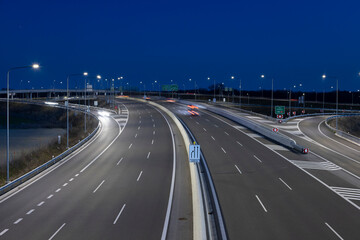 highway crossroad at night with modern street lights