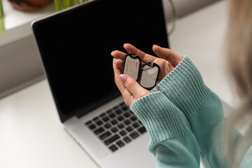 woman holding military token in hand