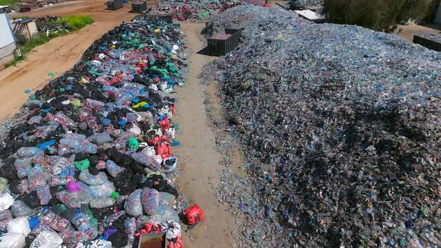 Plastic bottles and Trash Soda cans recycling piles in a local facility