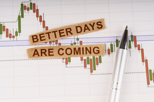 On the chart of business quotes lies a pen and torn paper with the inscription - Better Days Are Coming