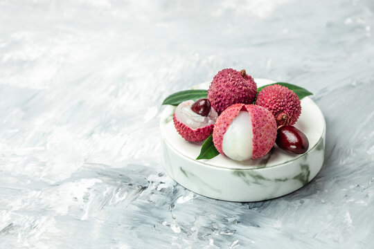 Fresh juicy lychee fruit. Organic lychee fruit concept. Exotic tropical litschi berry on a light background. tropical fruit summer in Thailand. place for text, top view