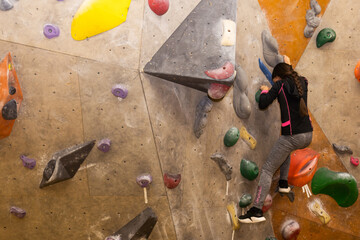 Youngster's effort in climbing a wall to reach the top.