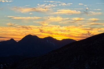 The sun sets and dusk falls on the Angeles Crest Highway, a winding route through the San Gabriel Mountains and Angeles National Forest just north of Los Angeles