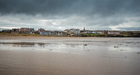 Wide picturesque panorama of sandy beach at Castlerock, Northern Ireland on cloudy spring day. Dark...