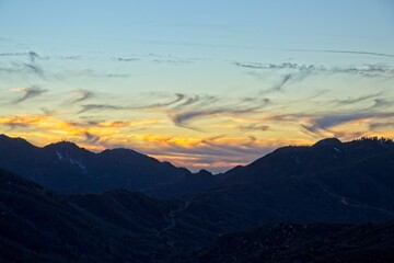 The sun sets and dusk falls on the Angeles Crest Highway, a winding route through the San Gabriel Mountains and Angeles National Forest just north of Los Angeles