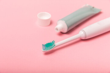 Smart electric toothbrush and toothpaste.Modern technologies for health. Healthy teeth. Dentistry concept. Charged via powerbank and controlled by an app on a smartphone. Oral hygiene.
