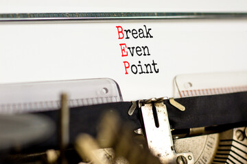 BEP break even point symbol. Concept words BEP break even point typed on retro old typewriter on a beautiful white paper background. Business and BEP break even point concept. Copy space.