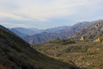 Fototapeta na wymiar The winding Angeles Crest Highway provides views over the Los Angeles Basin and surrounding urban valleys, the snow-dusted San Gabriel and San Bernandino Mountains and the Mojave Desert