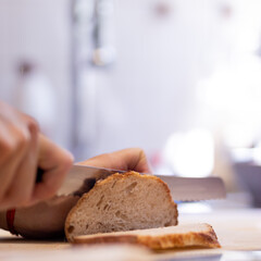 Caucasian man cutting bread on board