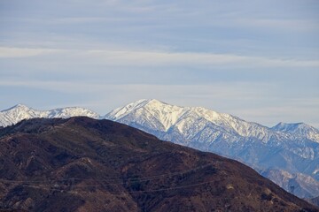 Naklejka na ściany i meble Snow dusts the San Gabriel Mountains that rise above Greater Los Angeles