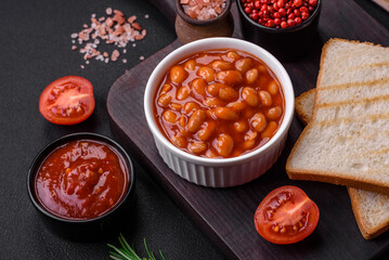 Delicious canned beans in a tomato in a white ceramic bowl