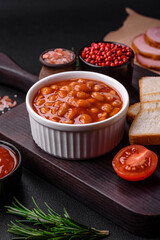 Fototapeta na wymiar Delicious canned beans in a tomato in a white ceramic bowl