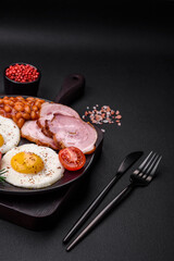Delicious nutritious English breakfast with fried eggs and tomatoes