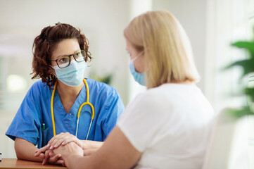 Doctor examining sick patient. Ill woman in clinic