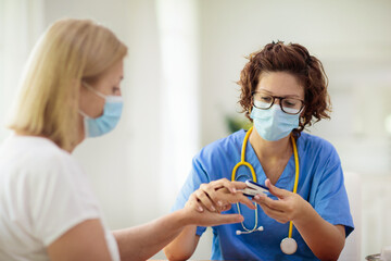 Doctor examining sick patient. Ill woman in clinic