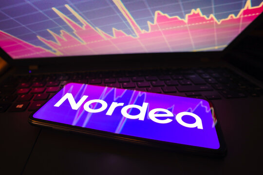 March 21, 2023, Brazil. In this photo illustration the Nordea logo seen displayed on a smartphone screen, with graphic representation of the stock market in the background.