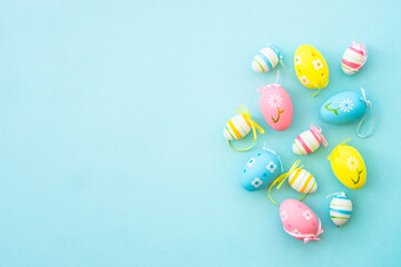 Easter background on blue. Colored easter eggs. Flat lay with copy space.