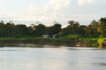 Views from the Amazon river of a shanty village houses, depicting people's lifestyle at Amazonas riverbank