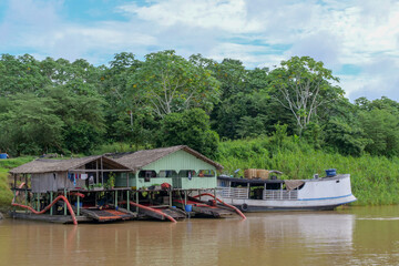 Fototapeta premium Primitive gold mining operations on the Amazon river in the Amazon rainforest in Brazil, 2023.