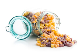 Pasta of various scary shapes in jar. Uncooked halloween pasta isolated on white background.