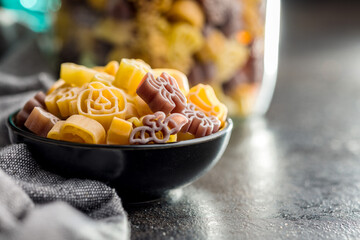 Pasta of various scary shapes. Uncooked halloween pasta in bowl.