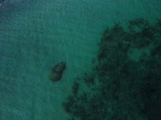 Beach and waves from top view. Turquoise water background from top view. 