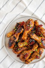 Homemade Easy Sticky Chicken Drumsticks on a Plate, top view. Overhead, from above, flat lay.
